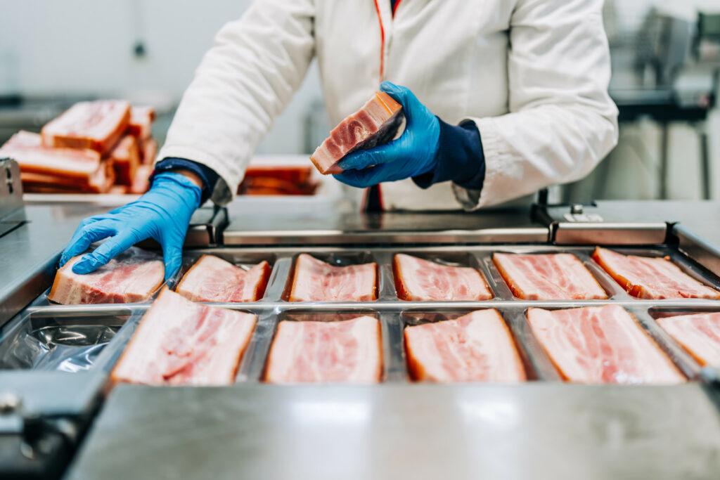 Bacon is being processed and packaged at a plant. Photo: Shutterstock